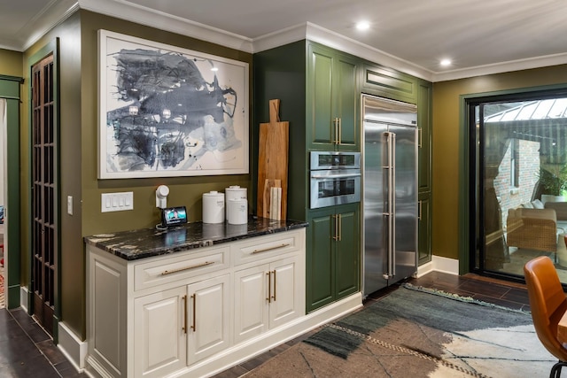 1702 Stokes Ln, Nashville, TN 37215 - kitchen with appliances with stainless steel finishes, green cabinetry, dark stone countertops, crown molding, and white cabinetry