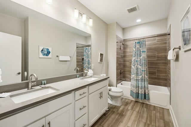 64 Fern Ave Unit 3, Nashville, TN 37207 - full bathroom featuring toilet, shower / bath combo with shower curtain, double vanity, and recessed lighting
