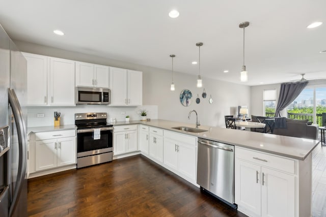 64 Fern Ave Unit 3, Nashville, TN 37207 - kitchen featuring stainless steel appliances, a peninsula, a sink, recessed lighting, and decorative backsplash