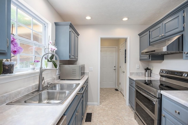 1077 Kathryn Rd, Mount Juliet, TN 37122 - kitchen with appliances with stainless steel finishes, under cabinet range hood, a sink, light countertops, and recessed lighting