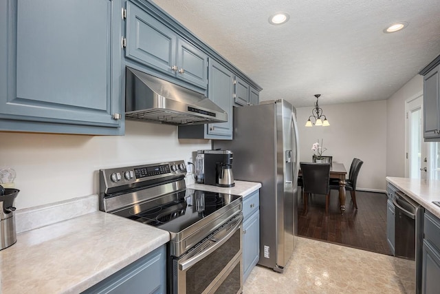 1077 Kathryn Rd, Mount Juliet, TN 37122 - kitchen with appliances with stainless steel finishes, under cabinet range hood, light countertops, blue cabinets, and a chandelier