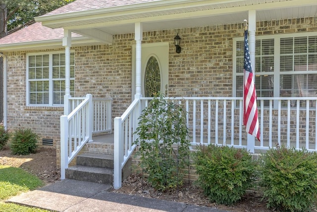 1077 Kathryn Rd, Mount Juliet, TN 37122 - view of exterior entry with brick siding, a porch, and roof with shingles