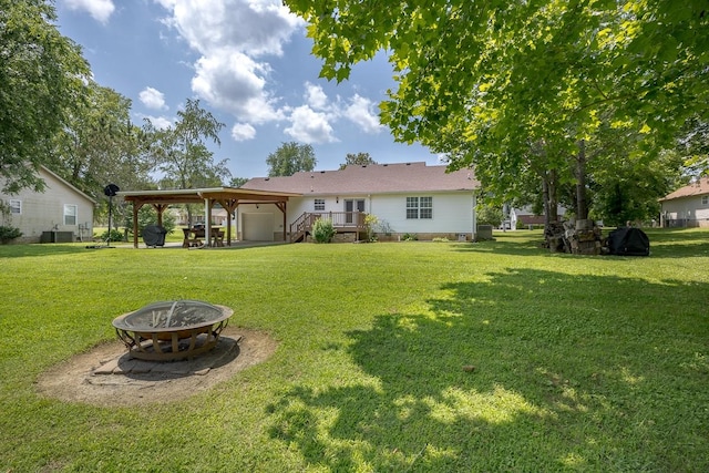 1077 Kathryn Rd, Mount Juliet, TN 37122 - rear view of property with an outdoor fire pit and a yard