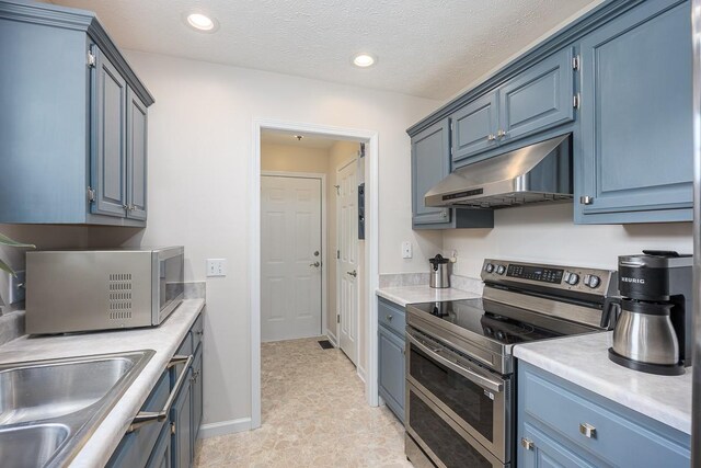 1077 Kathryn Rd, Mount Juliet, TN 37122 - kitchen with appliances with stainless steel finishes, under cabinet range hood, light countertops, blue cabinetry, and recessed lighting