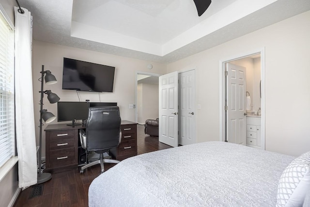 1077 Kathryn Rd, Mount Juliet, TN 37122 - bedroom with dark wood-style flooring, a tray ceiling, a desk, ensuite bathroom, and baseboards