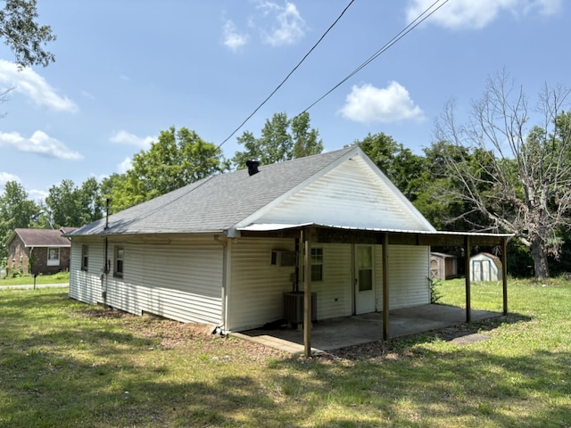 117 Rob Rd, Clarksville, TN 37040 - rear view of house with a lawn, roof with shingles, and a carport