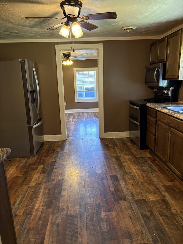 117 Rob Rd, Clarksville, TN 37040 - kitchen featuring stainless steel appliances, ceiling fan, dark wood finished floors, baseboards, and ornamental molding