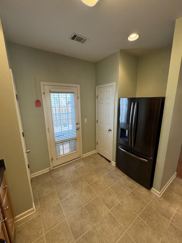 1101 Downs Blvd Unit 312, Franklin, TN 37064 - kitchen featuring black fridge, baseboards, light tile patterned flooring, and recessed lighting