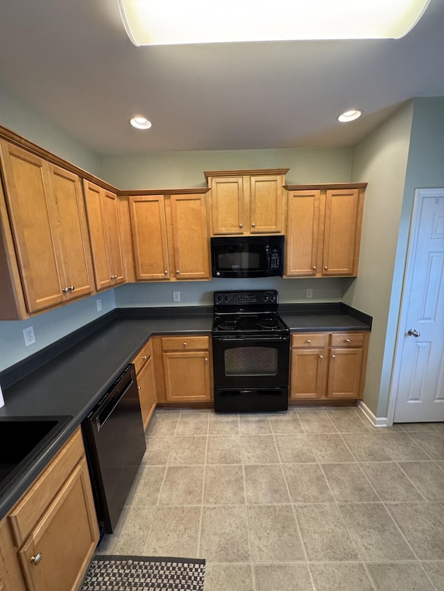 1101 Downs Blvd Unit 312, Franklin, TN 37064 - kitchen with black appliances, dark countertops, a sink, recessed lighting, and brown cabinetry