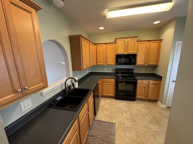 1101 Downs Blvd Unit 312, Franklin, TN 37064 - kitchen featuring black appliances, a sink, dark countertops, light tile patterned floors, and recessed lighting