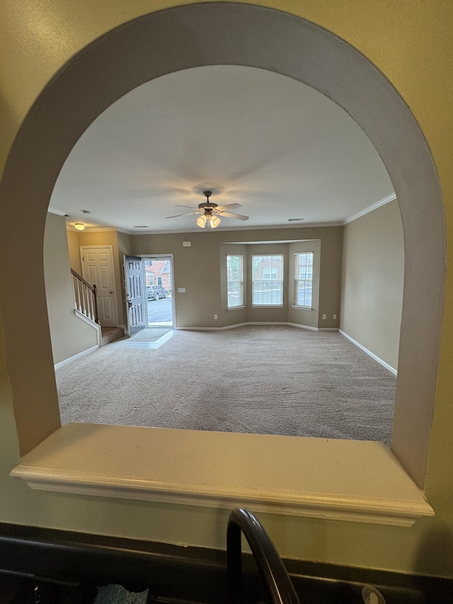 1101 Downs Blvd Unit 312, Franklin, TN 37064 - carpeted living area with arched walkways, baseboards, a ceiling fan, stairs, and crown molding