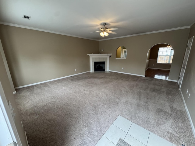1101 Downs Blvd Unit 312, Franklin, TN 37064 - unfurnished living room featuring a ceiling fan, carpet, ornamental molding, arched walkways, and baseboards