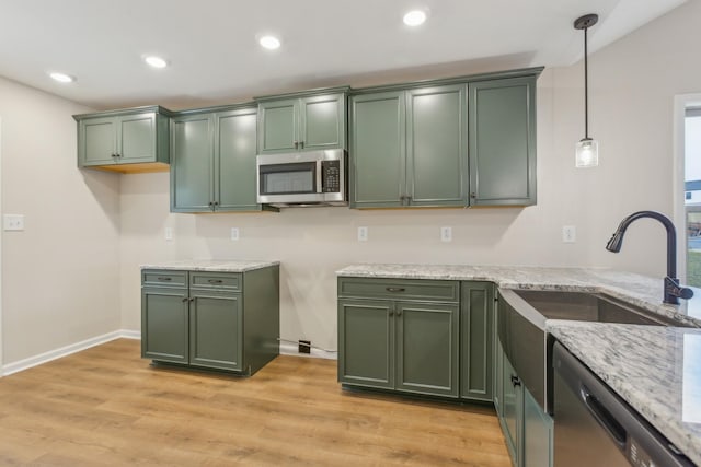 1445 Isaiah Dr, Clarksville, TN 37042 - kitchen with green cabinetry, appliances with stainless steel finishes, light stone countertops, and recessed lighting