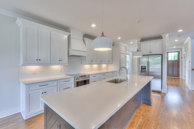 3104 Southlake Dr, Nashville, TN 37211 - kitchen with stainless steel appliances, a sink, custom exhaust hood, a large island with sink, and light wood-style flooring
