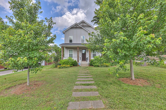 3104 Southlake Dr, Nashville, TN 37211 - view of front facade with board and batten siding, a front yard, and a porch