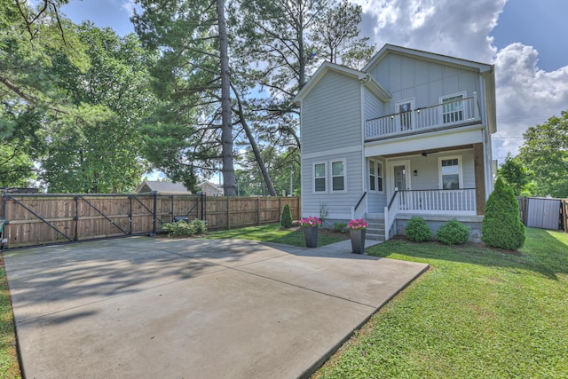 3104 Southlake Dr, Nashville, TN 37211 - view of front of home with a balcony, a gate, board and batten siding, and covered porch