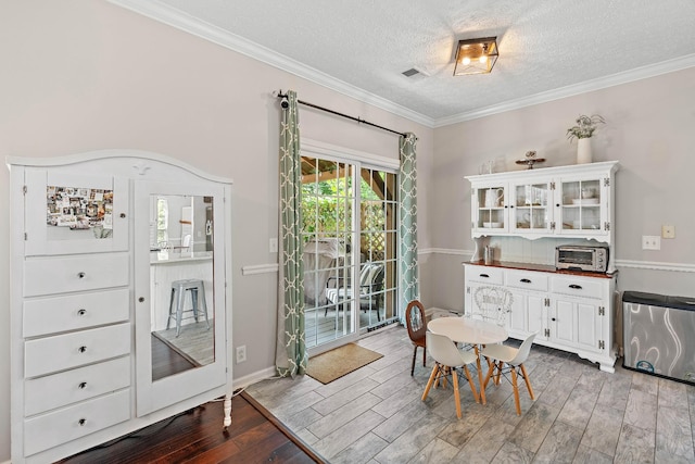 503 Hollyhock Way, Franklin, TN 37064 - dining space featuring a textured ceiling, wood finished floors, ornamental molding, and baseboards