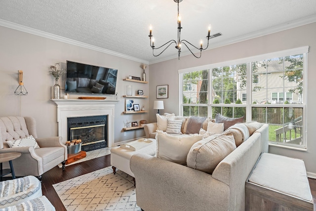 503 Hollyhock Way, Franklin, TN 37064 - living area featuring wood finished floors, a chandelier, crown molding, a fireplace with flush hearth, and a textured ceiling