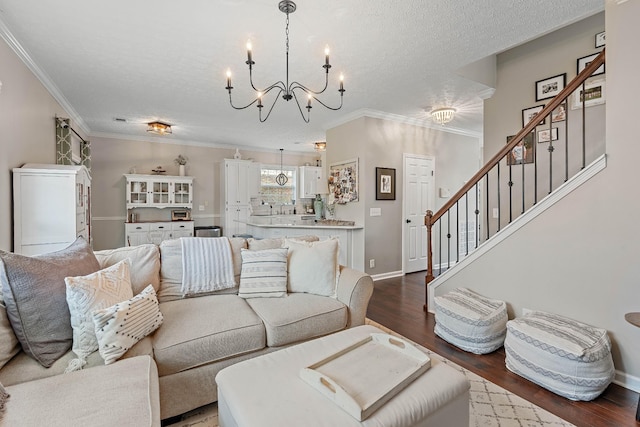 503 Hollyhock Way, Franklin, TN 37064 - living room with a chandelier, crown molding, dark wood-style floors, stairway, and a textured ceiling