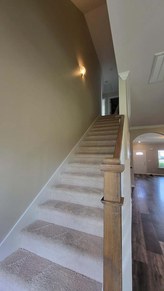 1060 Brayden Dr, Fairview, TN 37062 - stairway featuring arched walkways, wood finished floors, and high vaulted ceiling