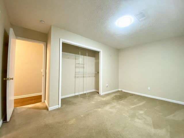 120 Holloway Dr, Lebanon, TN 37087 - unfurnished bedroom with a closet, carpet flooring, baseboards, and a textured ceiling