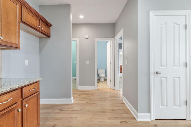 193 Red Jacket Trce, Murfreesboro, TN 37127 - kitchen featuring brown cabinets, light wood-style flooring, baseboards, light stone countertops, and recessed lighting