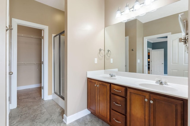 193 Red Jacket Trce, Murfreesboro, TN 37127 - bathroom with a walk in closet, a shower stall, double vanity, and baseboards