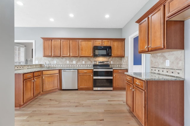 193 Red Jacket Trce, Murfreesboro, TN 37127 - kitchen with appliances with stainless steel finishes, a sink, brown cabinetry, light wood-style flooring, and recessed lighting