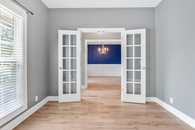 193 Red Jacket Trce, Murfreesboro, TN 37127 - spare room with french doors, wood finished floors, a chandelier, and baseboards