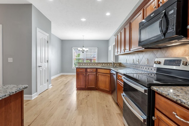 193 Red Jacket Trce, Murfreesboro, TN 37127 - kitchen featuring appliances with stainless steel finishes, a chandelier, decorative backsplash, light wood-style floors, and a peninsula