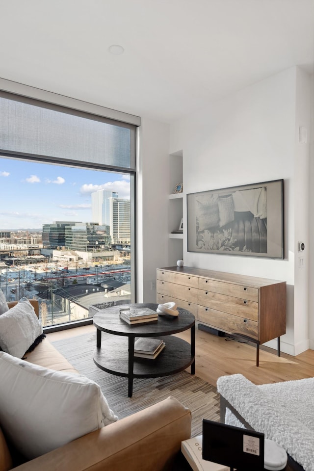1212 Demonbreun St Unit A3 O, Nashville, TN 37203 - living room with wood finished floors, built in features, and a city view
