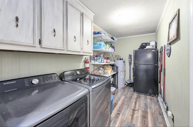 235 Pinecrest Dr, Henderson, TN 38340 - laundry room featuring cabinet space, water heater, separate washer and dryer, light wood-type flooring, and crown molding