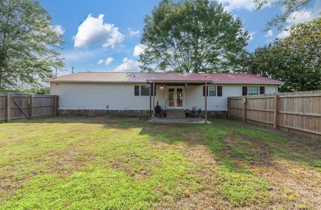 235 Pinecrest Dr, Henderson, TN 38340 - rear view of property featuring french doors, a patio, and metal roof