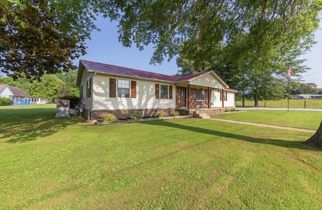 235 Pinecrest Dr, Henderson, TN 38340 - single story home with a front lawn and metal roof