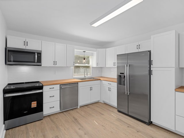400 Westover Dr, Columbia, TN 38401 - kitchen with stainless steel appliances, butcher block counters, a sink, light wood-style flooring, and backsplash