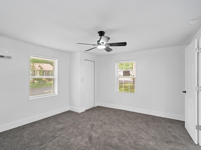 400 Westover Dr, Columbia, TN 38401 - unfurnished bedroom with dark colored carpet, baseboards, a closet, ceiling fan, and a wall unit AC