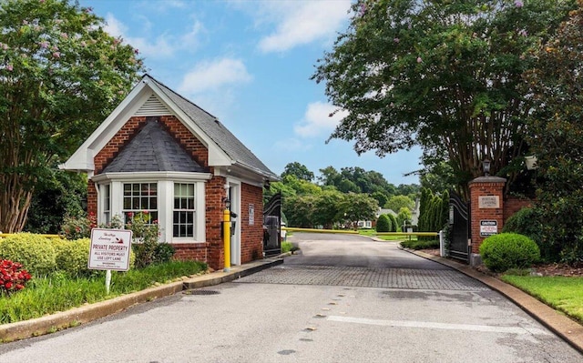 1284 Heritage Landing Dr, Chattanooga, TN 37405 - view of asphalt street featuring curbs, a gated entry, and street lights
