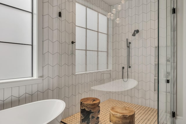 7313 Harlow Dr, College Grove, TN 37046 - full bathroom with tiled shower, a soaking tub, healthy amount of natural light, and tile walls