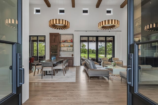 7313 Harlow Dr, College Grove, TN 37046 - living room featuring a towering ceiling, beam ceiling, wood finished floors, plenty of natural light, and french doors