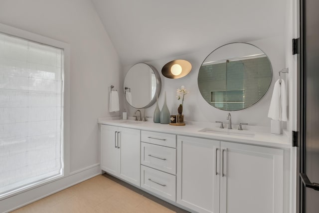 7313 Harlow Dr, College Grove, TN 37046 - bathroom featuring vaulted ceiling and double vanity