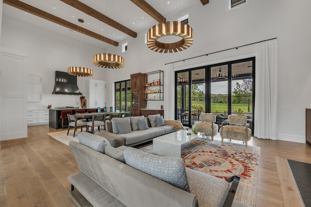 7313 Harlow Dr, College Grove, TN 37046 - living area featuring a high ceiling, beamed ceiling, light wood-style flooring, a chandelier, and recessed lighting