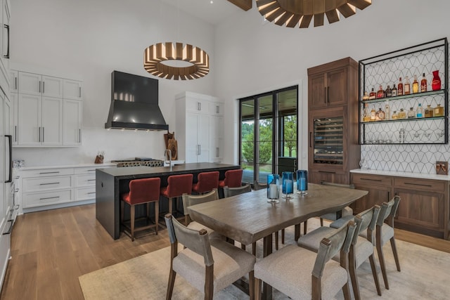 7313 Harlow Dr, College Grove, TN 37046 - dining room featuring a towering ceiling, light wood-style floors, and wine cooler