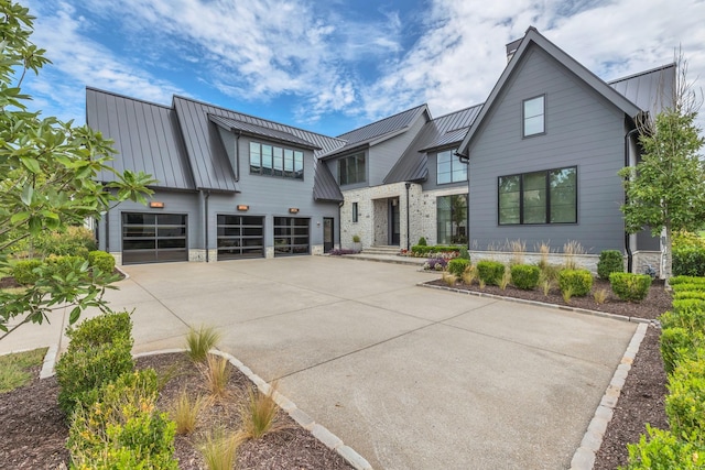 7313 Harlow Dr, College Grove, TN 37046 - view of front of home featuring driveway, an attached garage, a standing seam roof, and metal roof