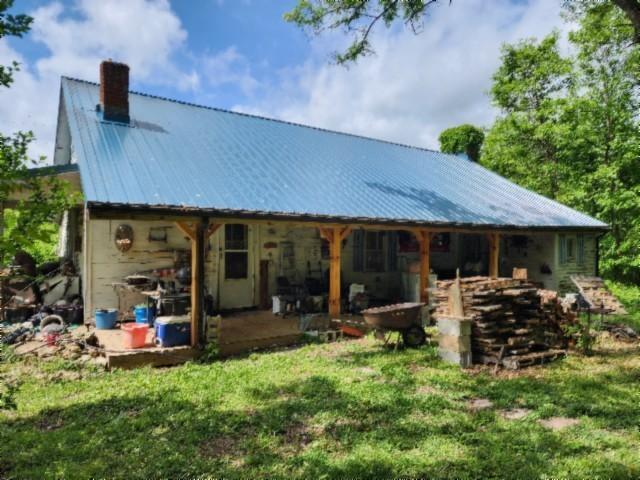 105 Log Home Ln, Moss, TN 38575 - rear view of property featuring a chimney, metal roof, and a yard