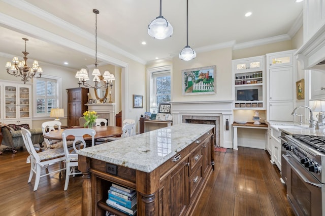 224 3rd Ave S, Franklin, TN 37064 - kitchen with a fireplace, a chandelier, white cabinets, dark wood-type flooring, and range with two ovens