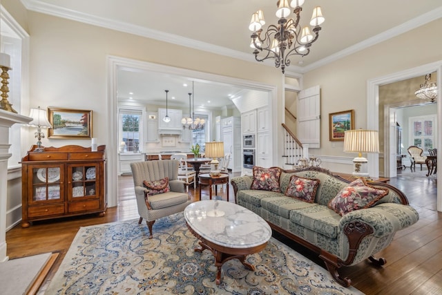 224 3rd Ave S, Franklin, TN 37064 - living area featuring a fireplace, a chandelier, ornamental molding, wood finished floors, and plenty of natural light