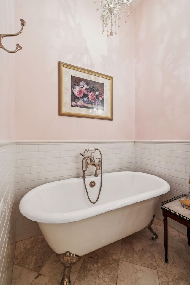 224 3rd Ave S, Franklin, TN 37064 - bathroom with tile walls, wainscoting, a soaking tub, and a chandelier