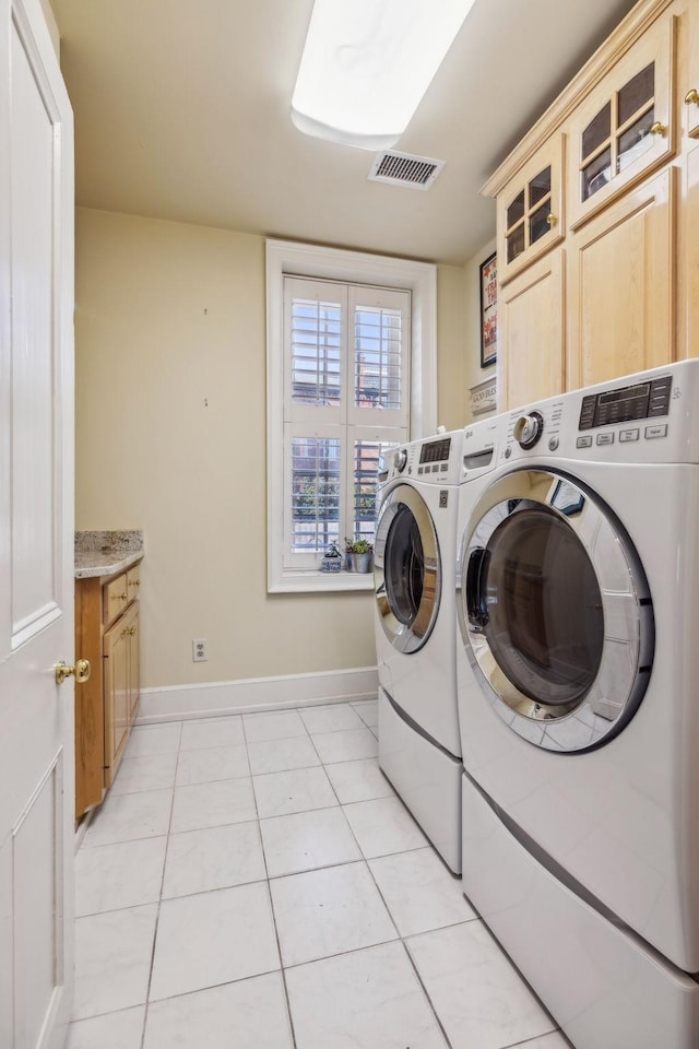 224 3rd Ave S, Franklin, TN 37064 - washroom with cabinet space, independent washer and dryer, baseboards, and light tile patterned floors