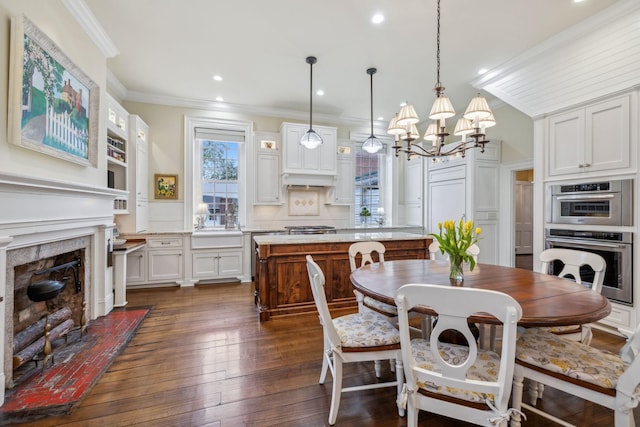 224 3rd Ave S, Franklin, TN 37064 - dining space featuring a chandelier, crown molding, dark wood-type flooring, a high end fireplace, and recessed lighting