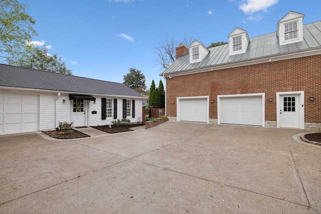 224 3rd Ave S, Franklin, TN 37064 - view of side of home featuring brick siding, concrete driveway, a chimney, and a garage
